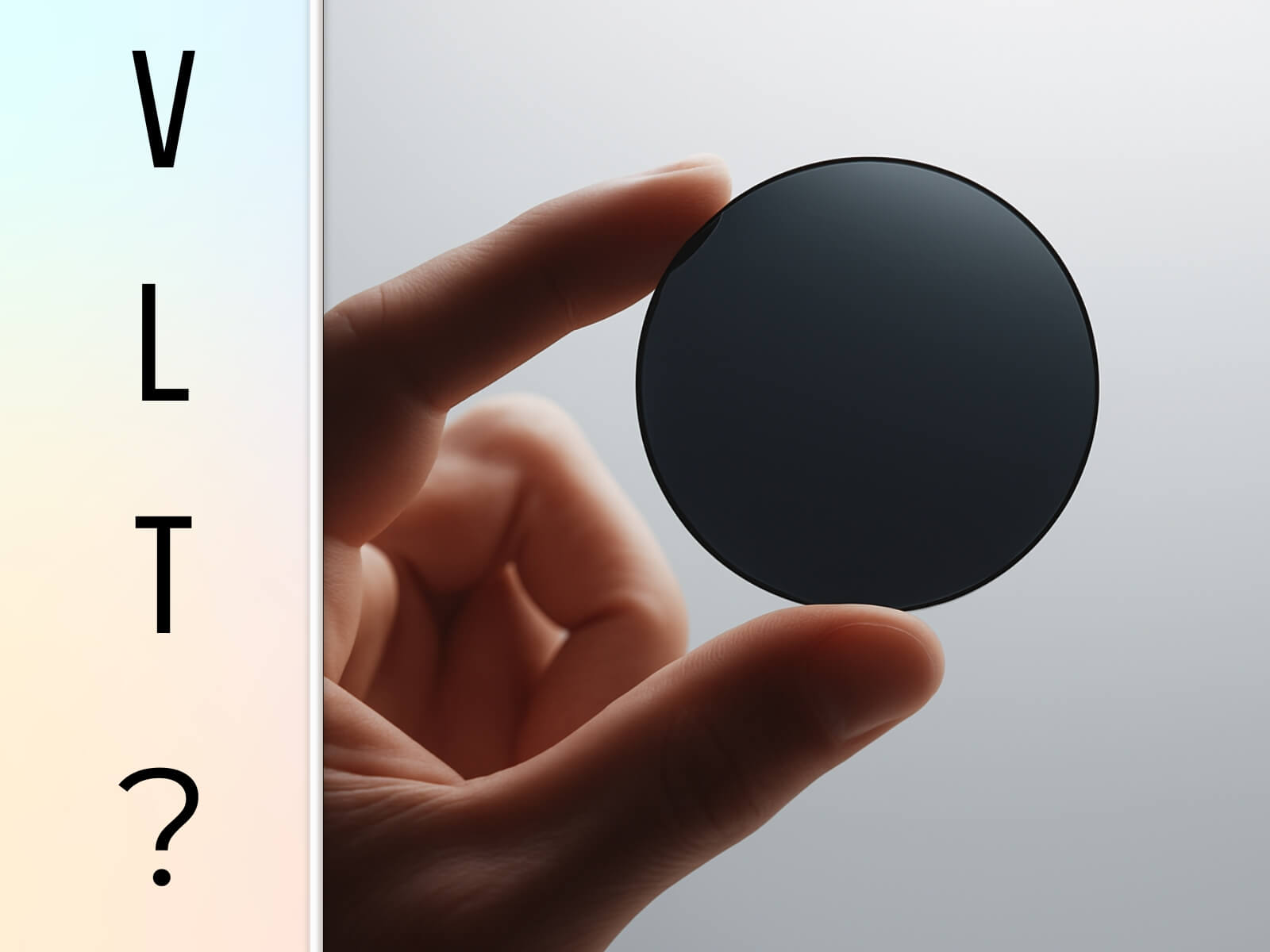 A hand holding a dark sunglass lens with the letters VLT on the side, symbolizing low light transmission sunglasses