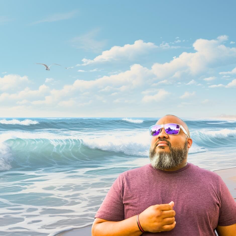 Man with beard in oversized sunglasses by the beach – big sunglasses for big heads.